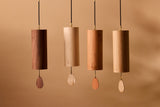 The four Koshi Earth Symphony chimes hanging side by side in walnut, maple, cherry and oak