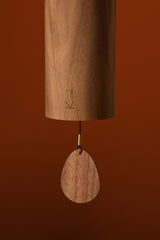 Close-up of the walnut body and clapper on the Koshi Earth Symphony Mountain chime